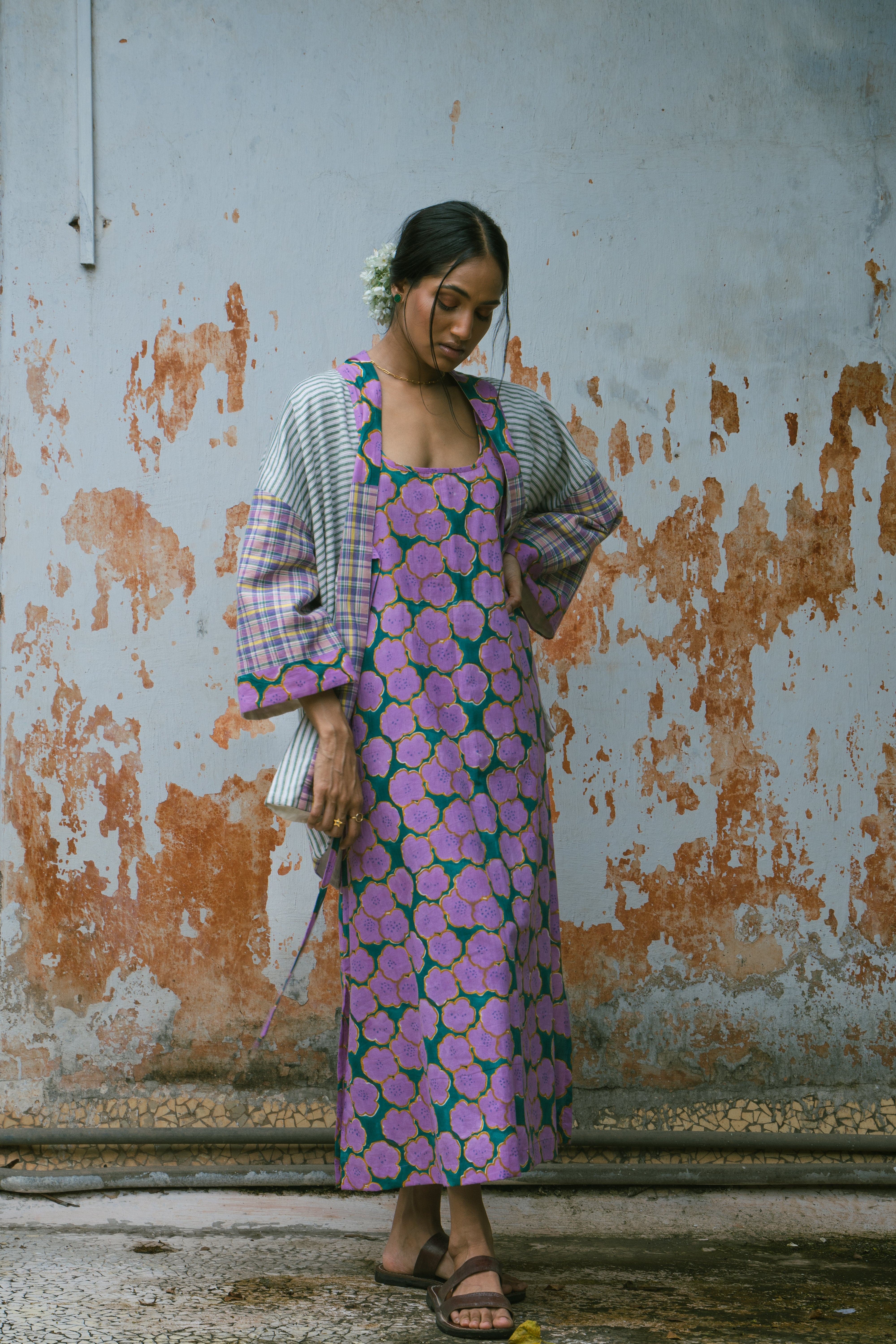 Deeta Clover slip dress displayed on a hanger, showcasing its lightweight fabric and simple, elegant design.