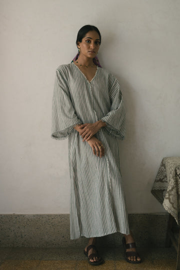 Deeta Afra dress in vibrant fabric, featuring a flowing silhouette and detailed neckline, perfect for elegant occasions.