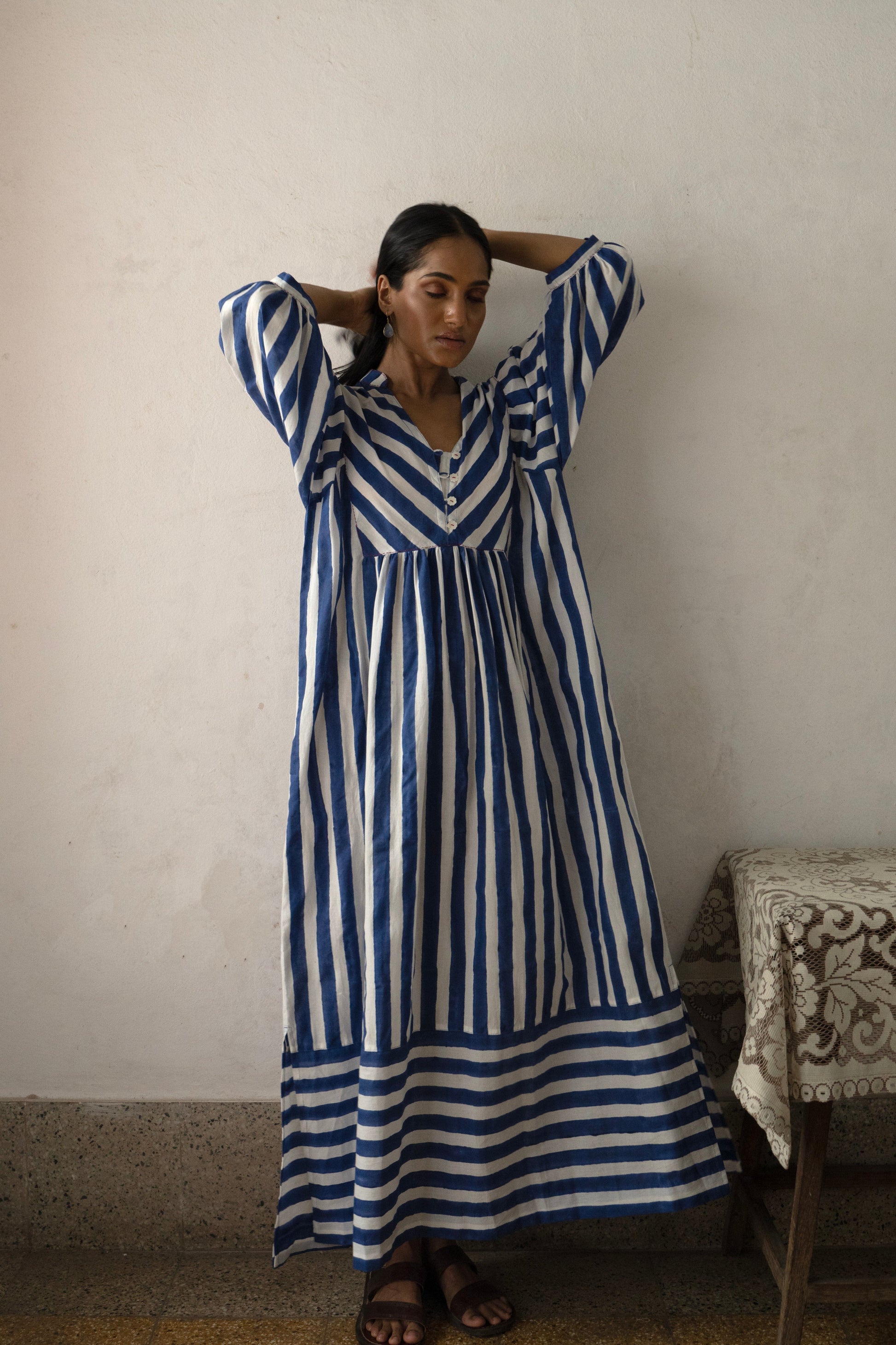 Deeta Nidar tea dress with floral pattern, lightweight fabric, and V-neck design, shown on a model.