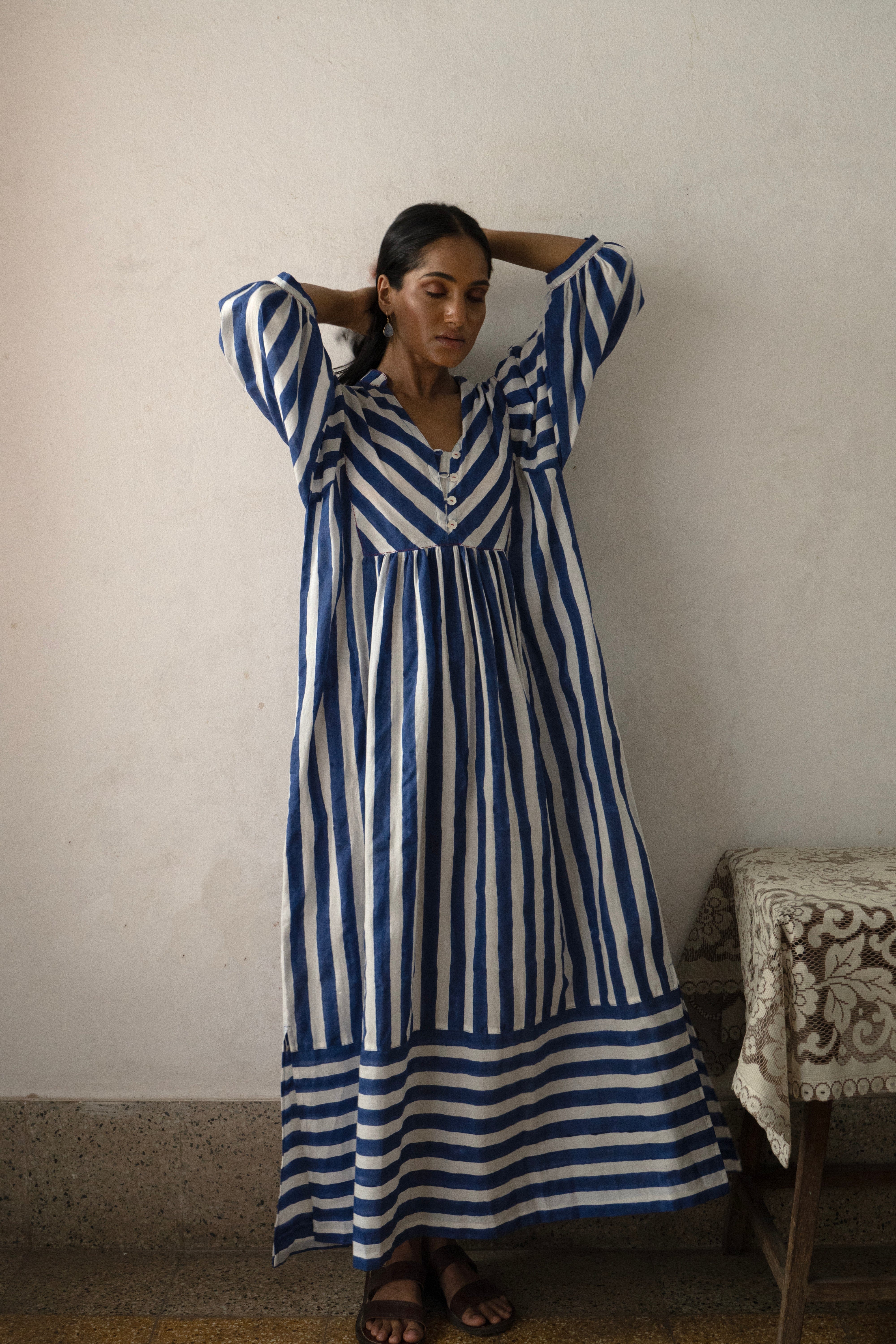 Deeta Nidar tea dress with floral pattern, lightweight fabric, and V-neck design, shown on a model.