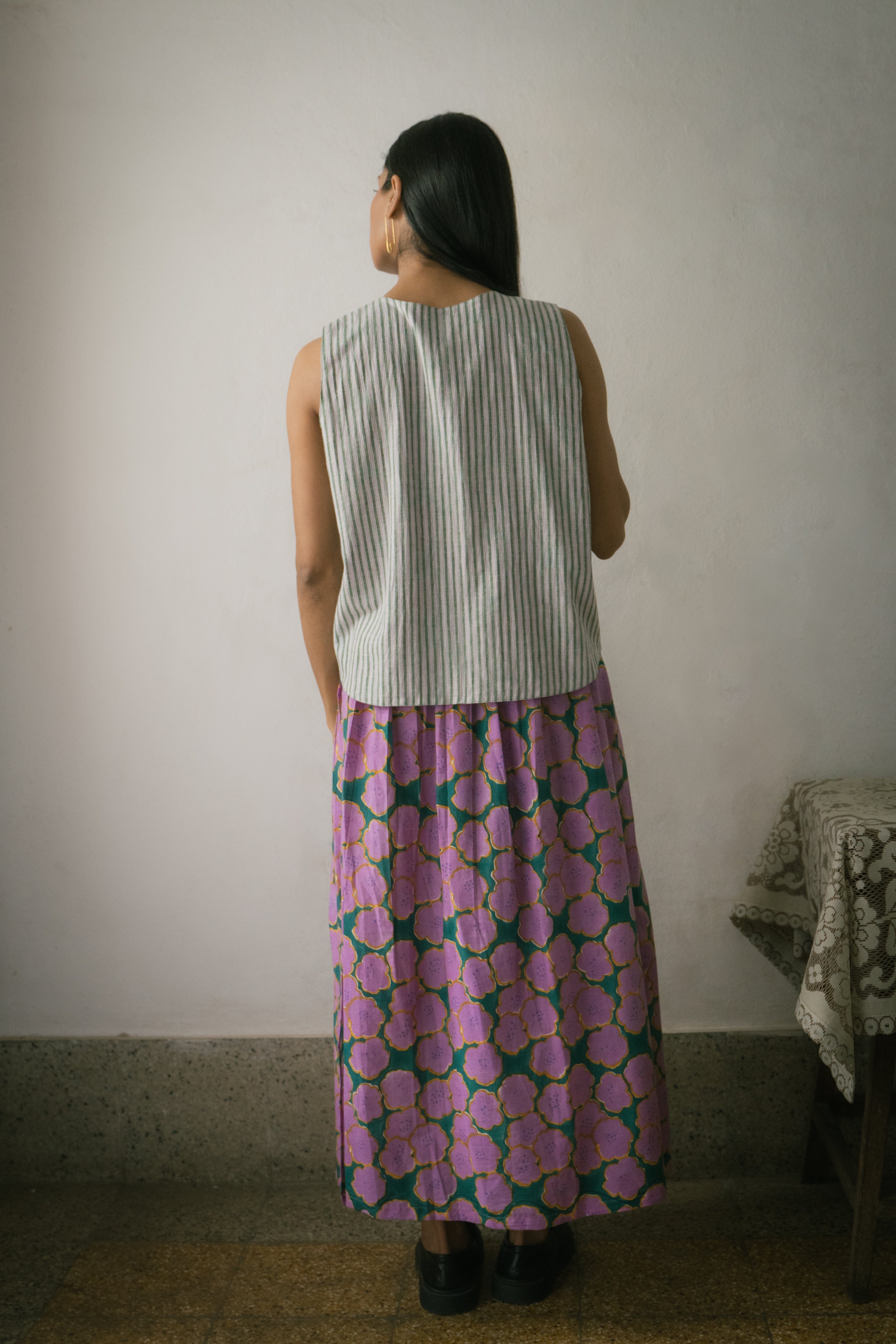 Deeta Clover skirt set featuring a stylish skirt and matching top in a green clover pattern on a white background.