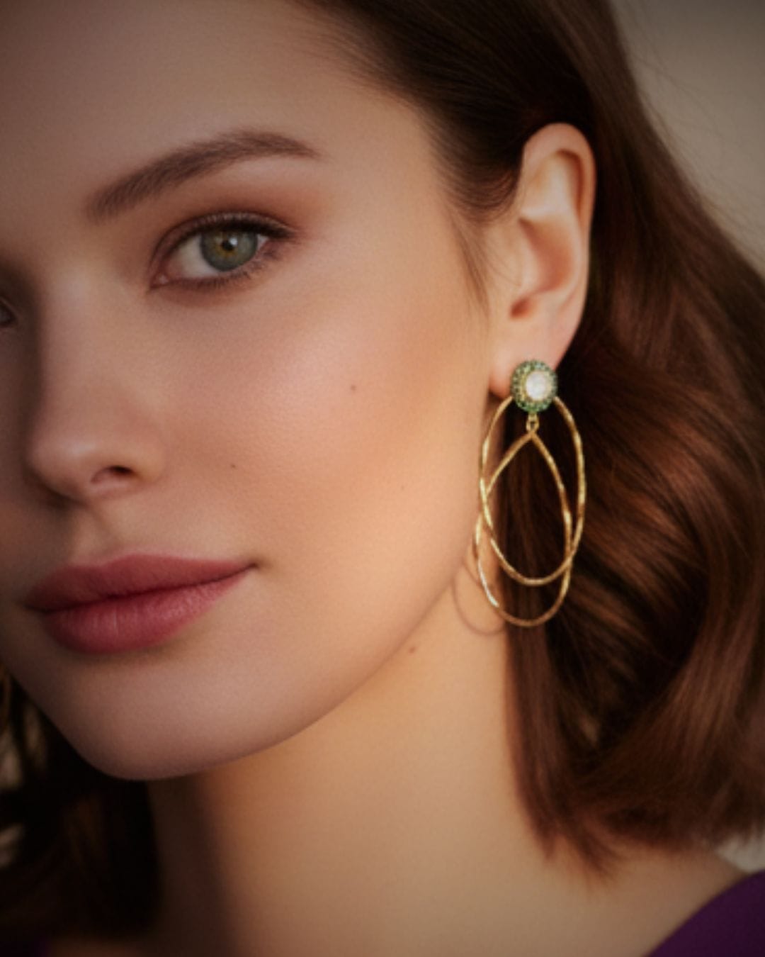 Bombaybirds Estrie earrings, elegant gold hoop earrings with intricate detailing, shown close-up against a neutral background.