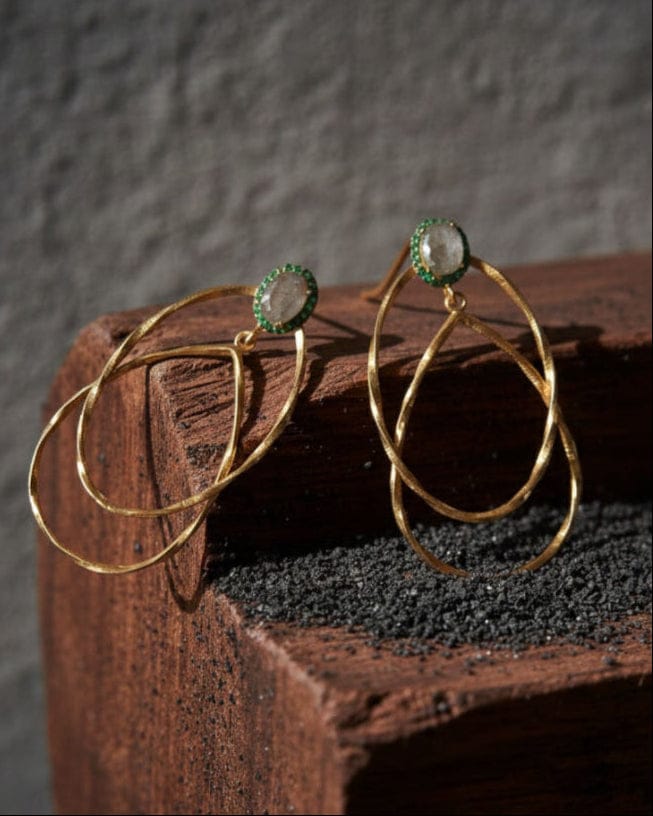 Bombaybirds Estrie earrings featuring gold-toned hoops with intricate detailing and a stylish, contemporary design.