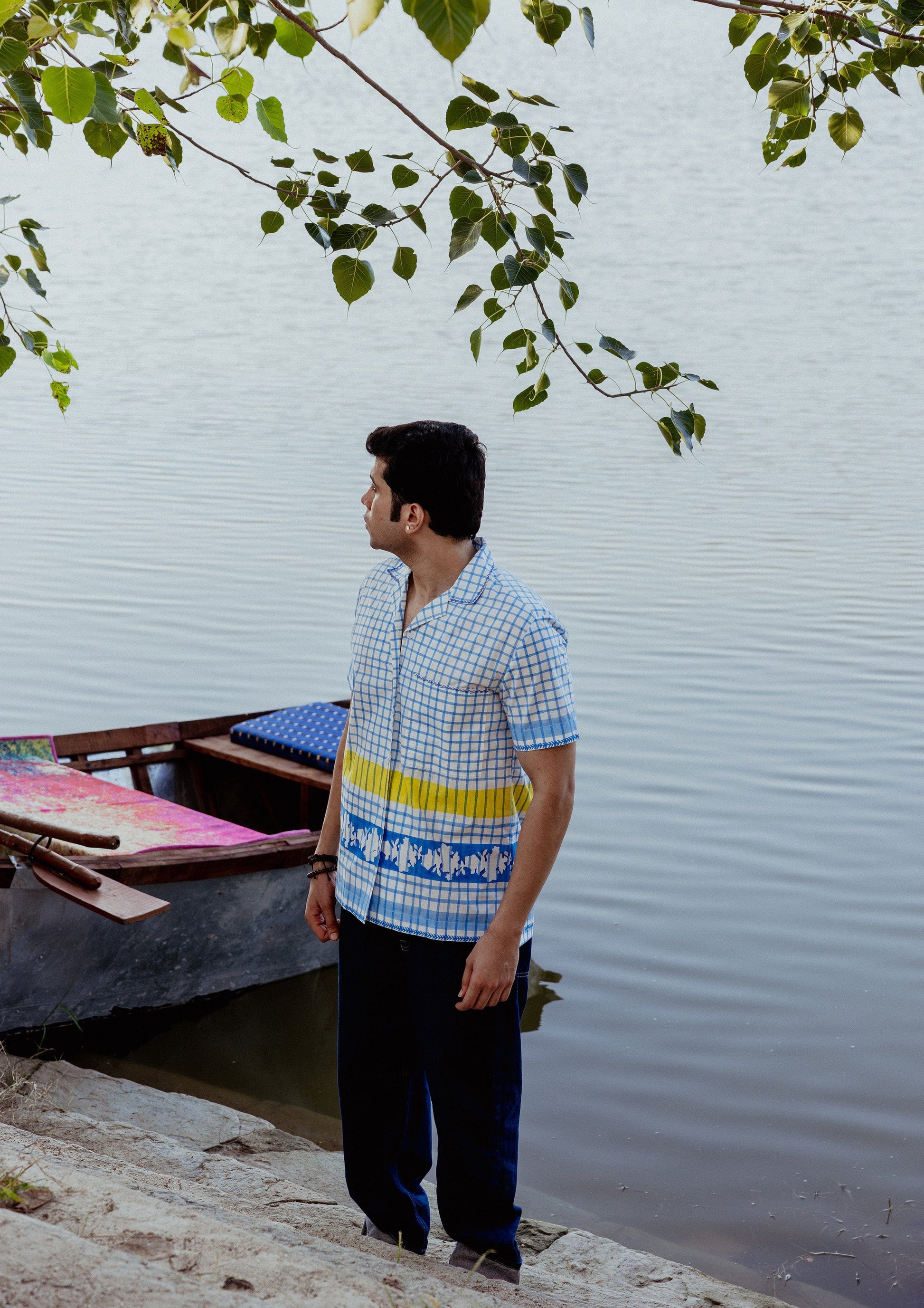 Blue check half sleeve shirt by The Raw India, featuring a casual fit and classic checkered pattern, displayed on a hanger.