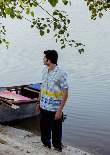 Blue check half sleeve shirt by The Raw India, featuring a casual fit and classic checkered pattern, displayed on a hanger.