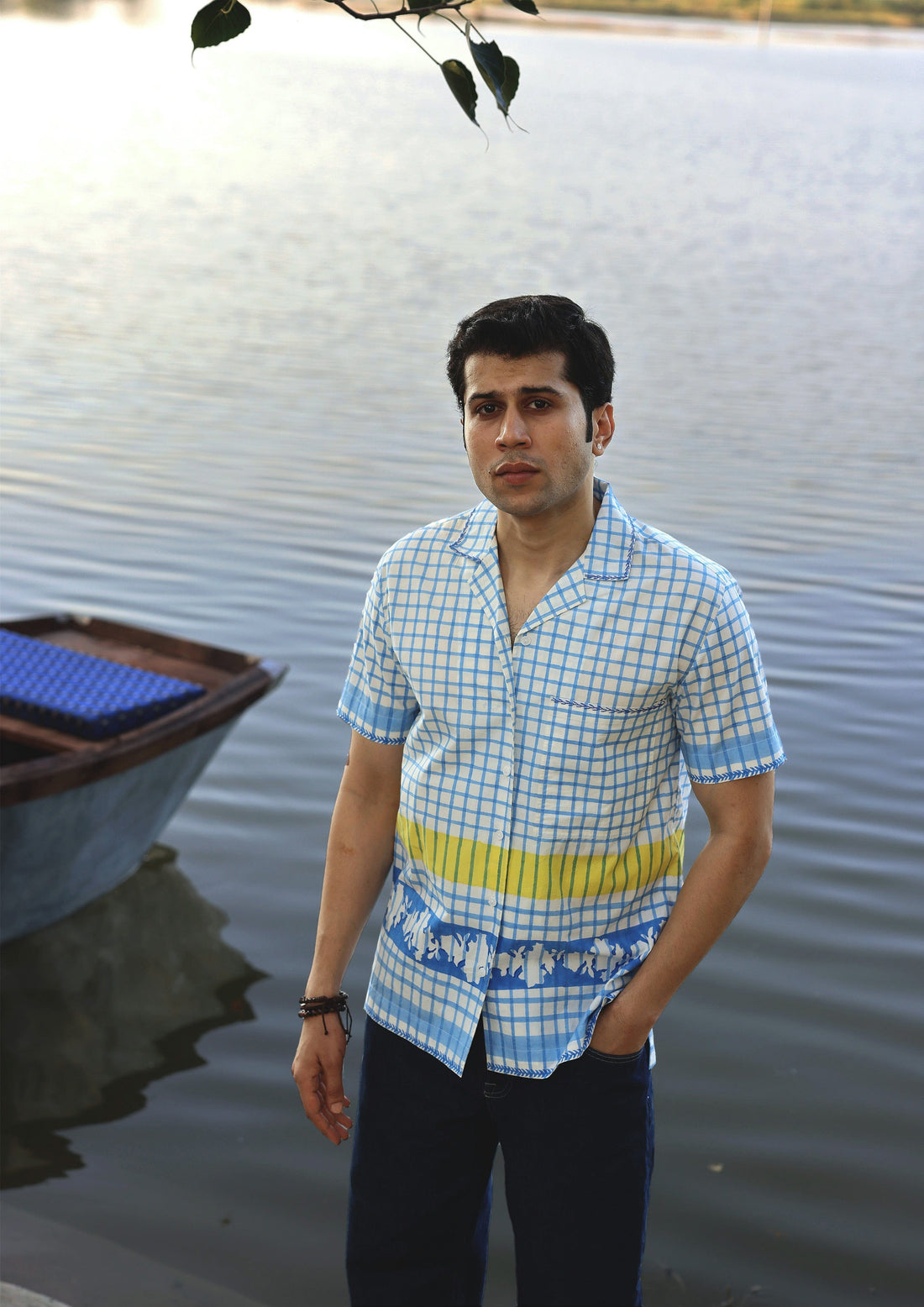 Blue check half sleeve shirt by The Raw India, featuring a casual fit and classic checkered pattern, displayed on a hanger.