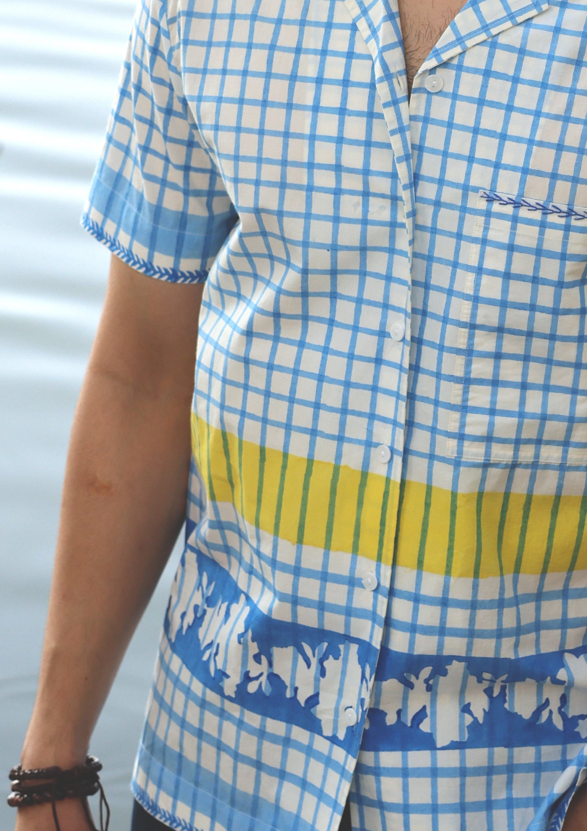 Blue checks half sleeve shirt by The Raw India displayed on a hanger, showcasing a casual, stylish shirt design.