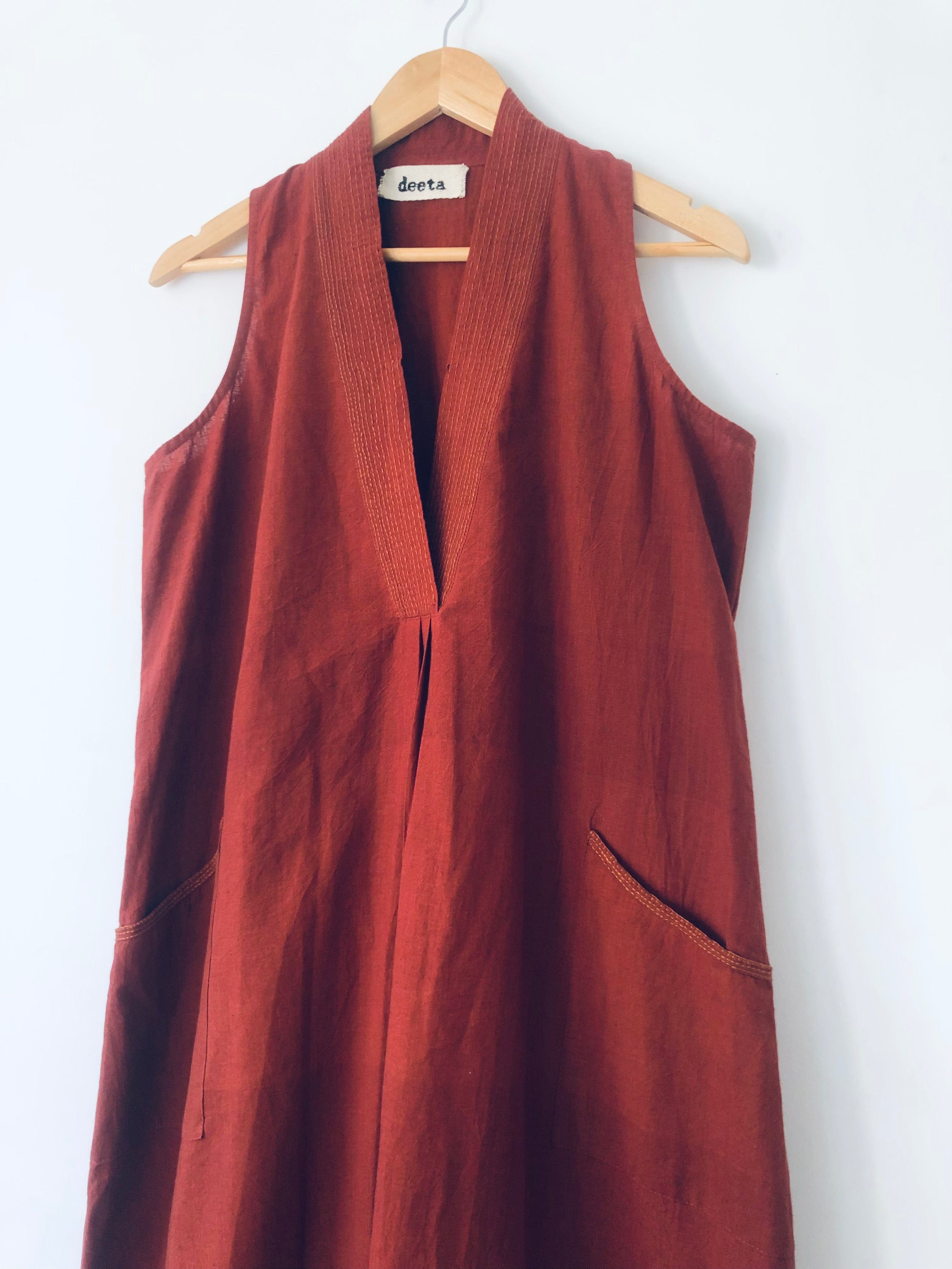 Deeta Bay dress displayed on a hanger with flowing fabric and vibrant colors, perfect for stylish summer wear.
