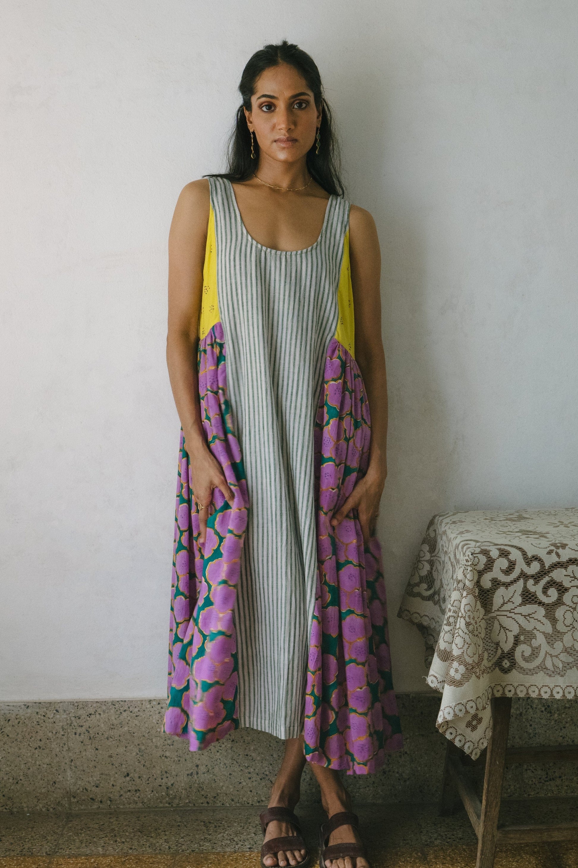 Deeta blooming patchwork dress with colorful floral patterns, sleeveless design, and flowing fabric.