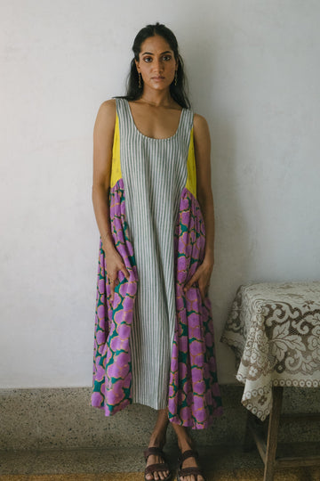 Deeta blooming patchwork dress with colorful floral patterns, sleeveless design, and flowing fabric.