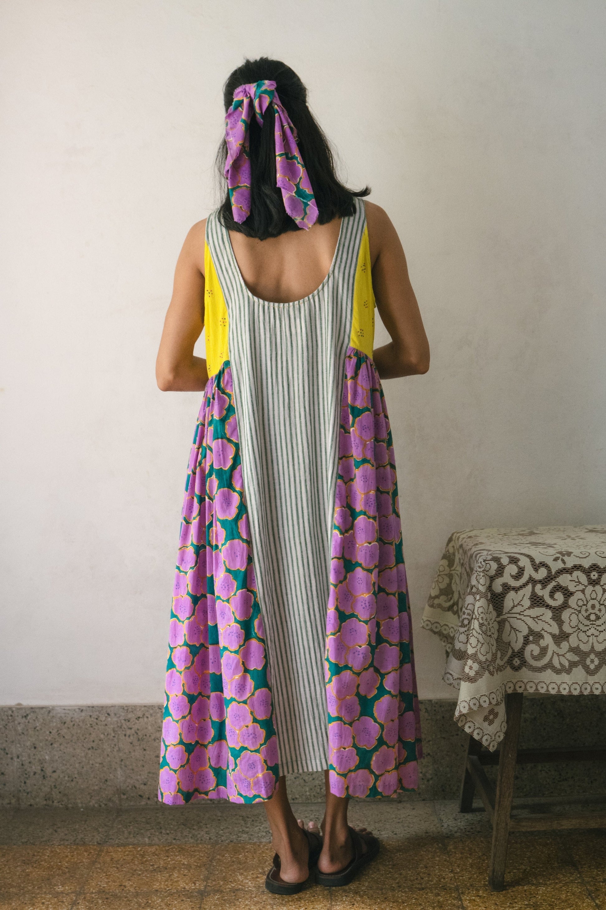 Deeta blooming patchwork dress featuring colorful floral patterns and a flowing design, perfect for casual or semi-formal wear.