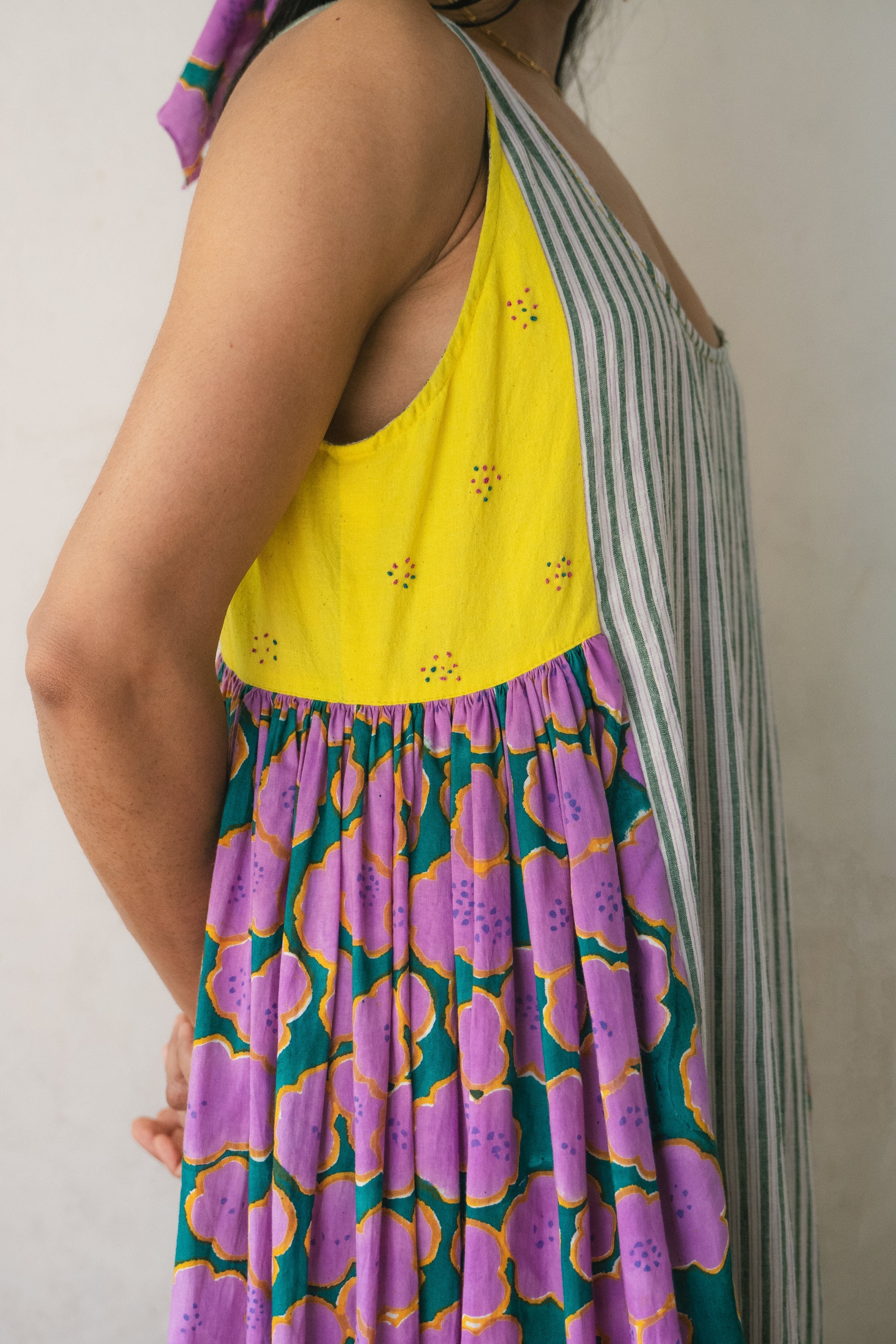 Colorful patchwork dress by Deeta featuring floral patterns and a flowing silhouette, perfect for casual or semi-formal wear.
