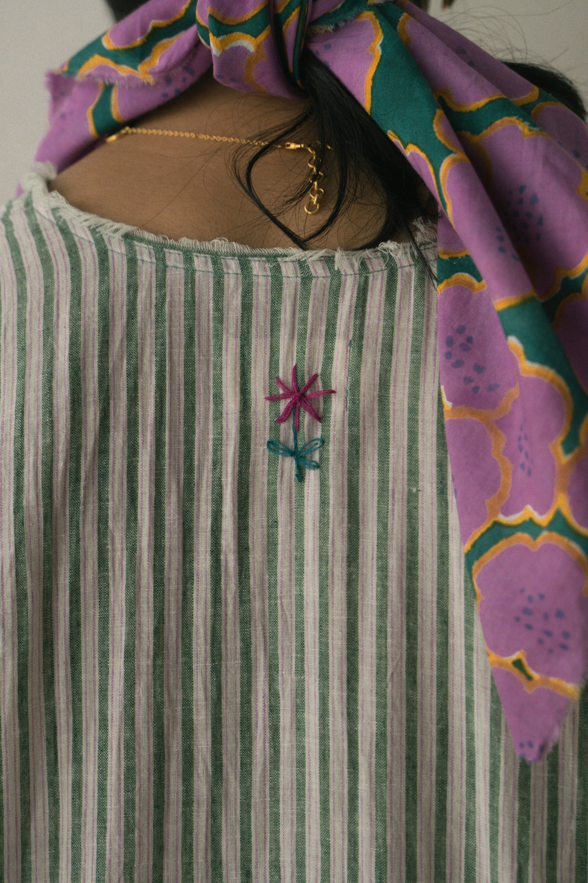 Deeta Afra dress displayed on a hanger, featuring a flowing fabric, stylish design, and vibrant colors suitable for casual or formal wear.