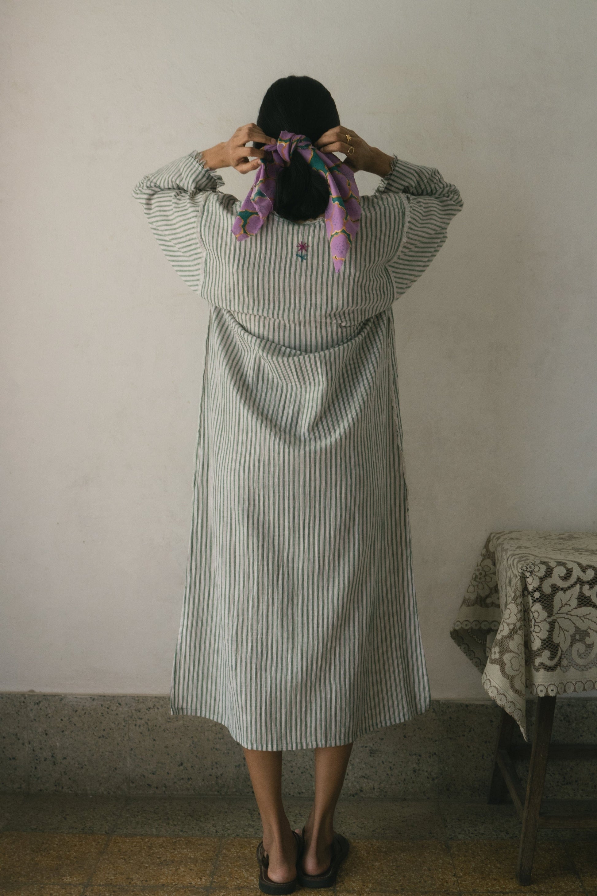 Deeta Afra dress displayed on a hanger, showcasing a stylish and elegant dress design with intricate details.