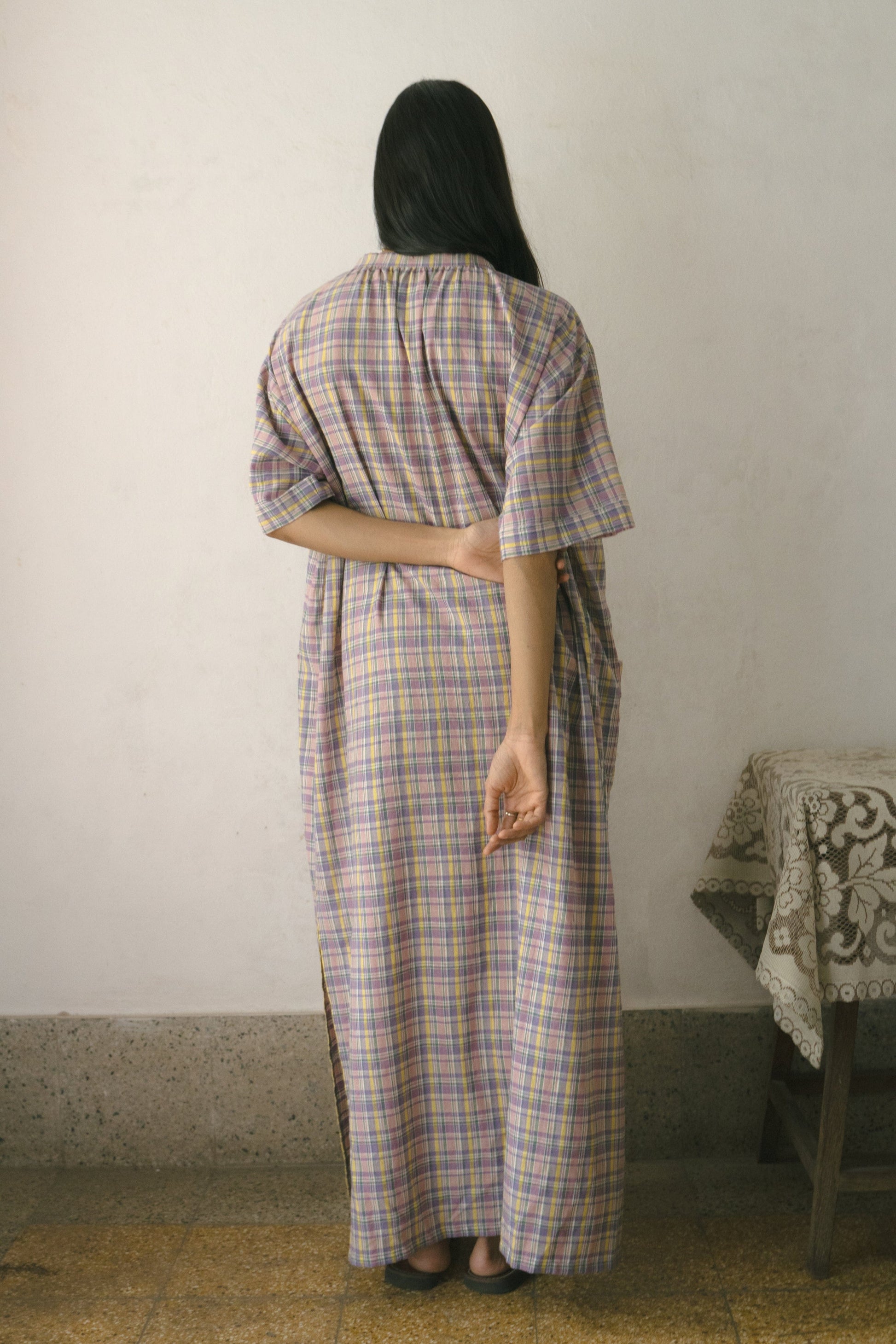 Deeta Meadow long tunic dress with flowing fabric, V-neckline, and long sleeves, displayed on a hanger.