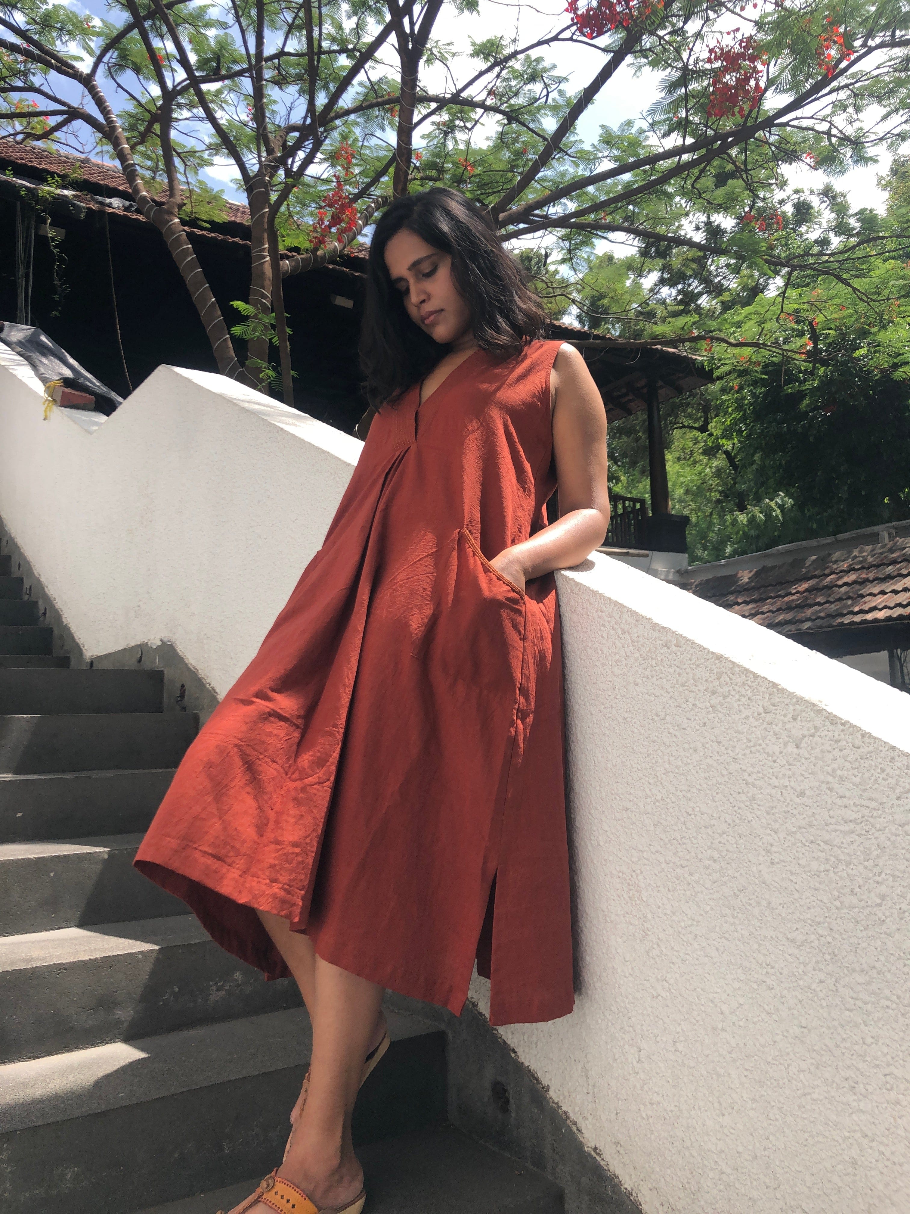 Deeta Bay dress showing a flowing fabric design with a fitted waist and elegant neckline, perfect for casual or formal wear.