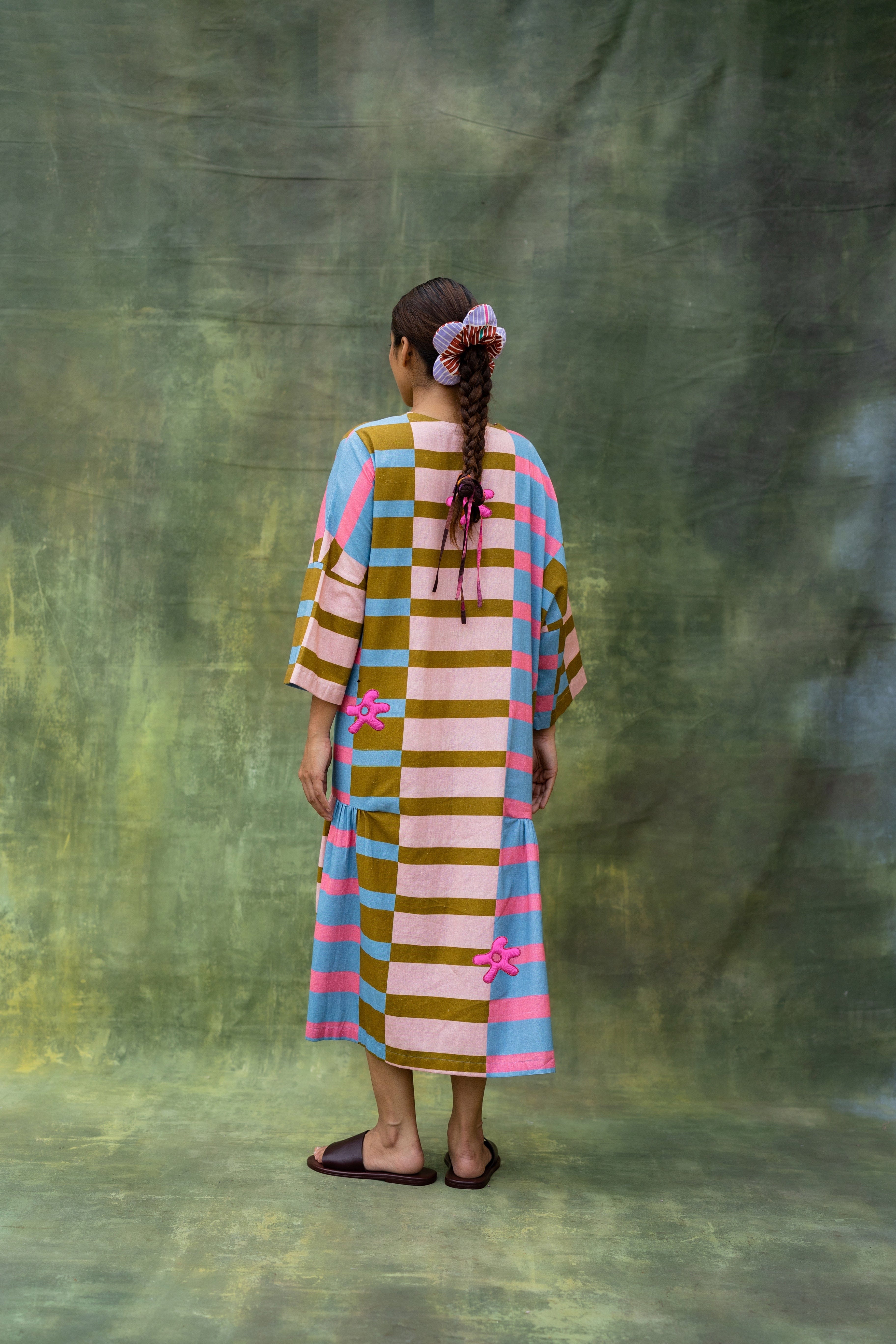 Doodlage Edith striped dress with a fitted bodice and flared skirt, featuring colorful horizontal stripes and short sleeves.