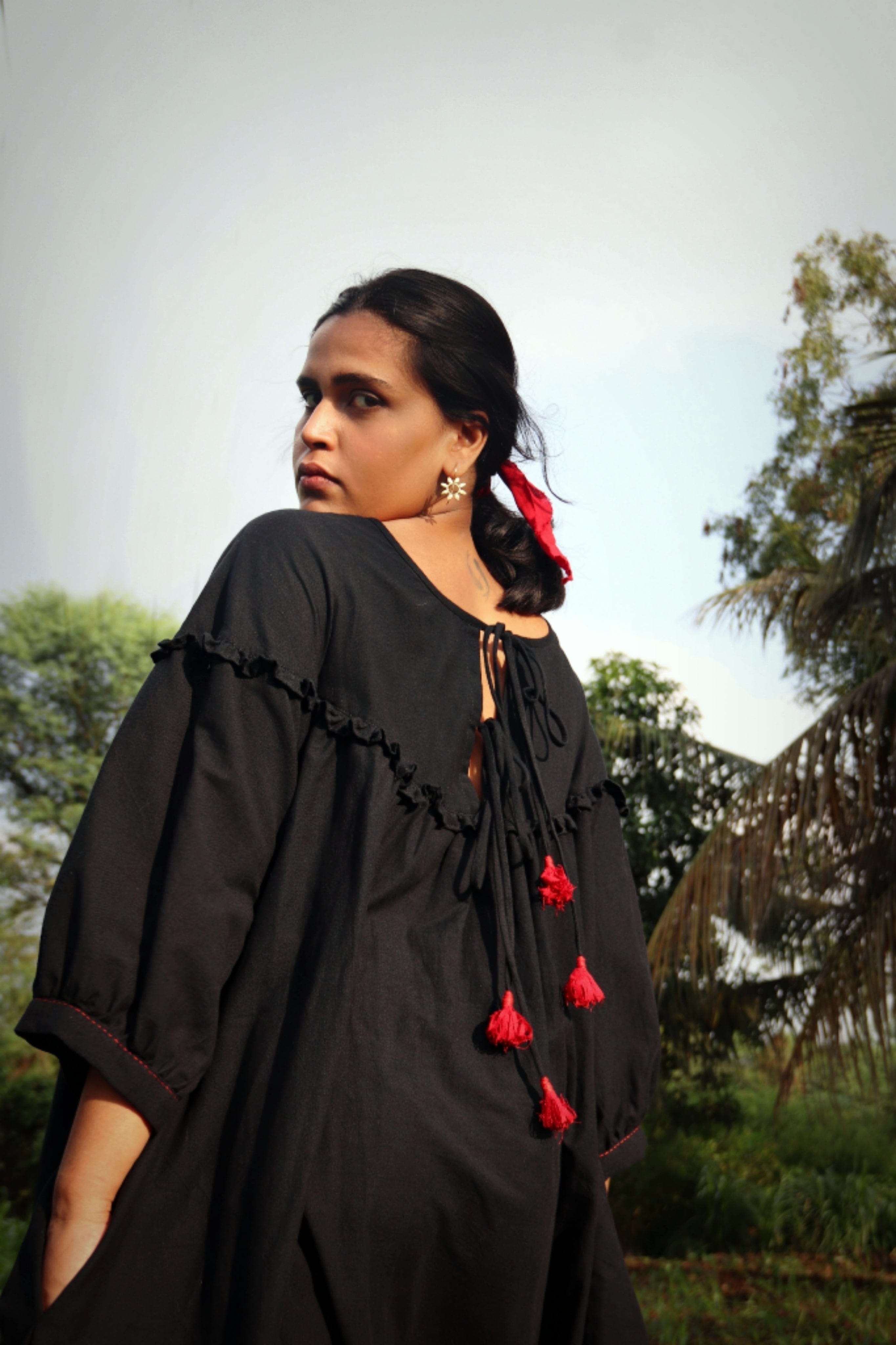 Black Raven Dress by Deeta featuring a stylish, flowing dress with intricate details and a sleek, elegant silhouette.
