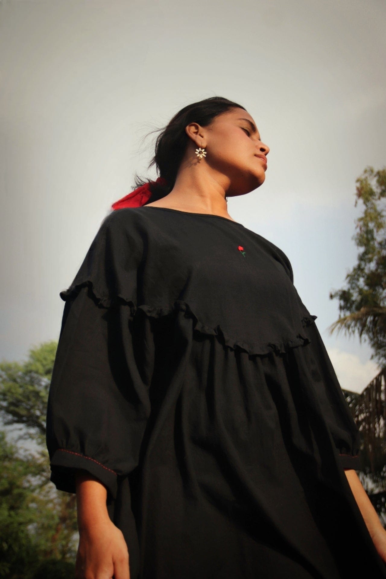 Black Raven dress by Deeta featuring a stylish, elegant design with a fitted silhouette and detailed fabric texture.