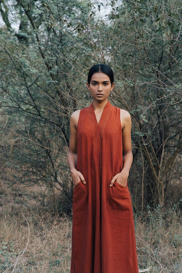 Deeta Bay dress featuring a flowing design with floral patterns, displayed on a hanger against a neutral background.