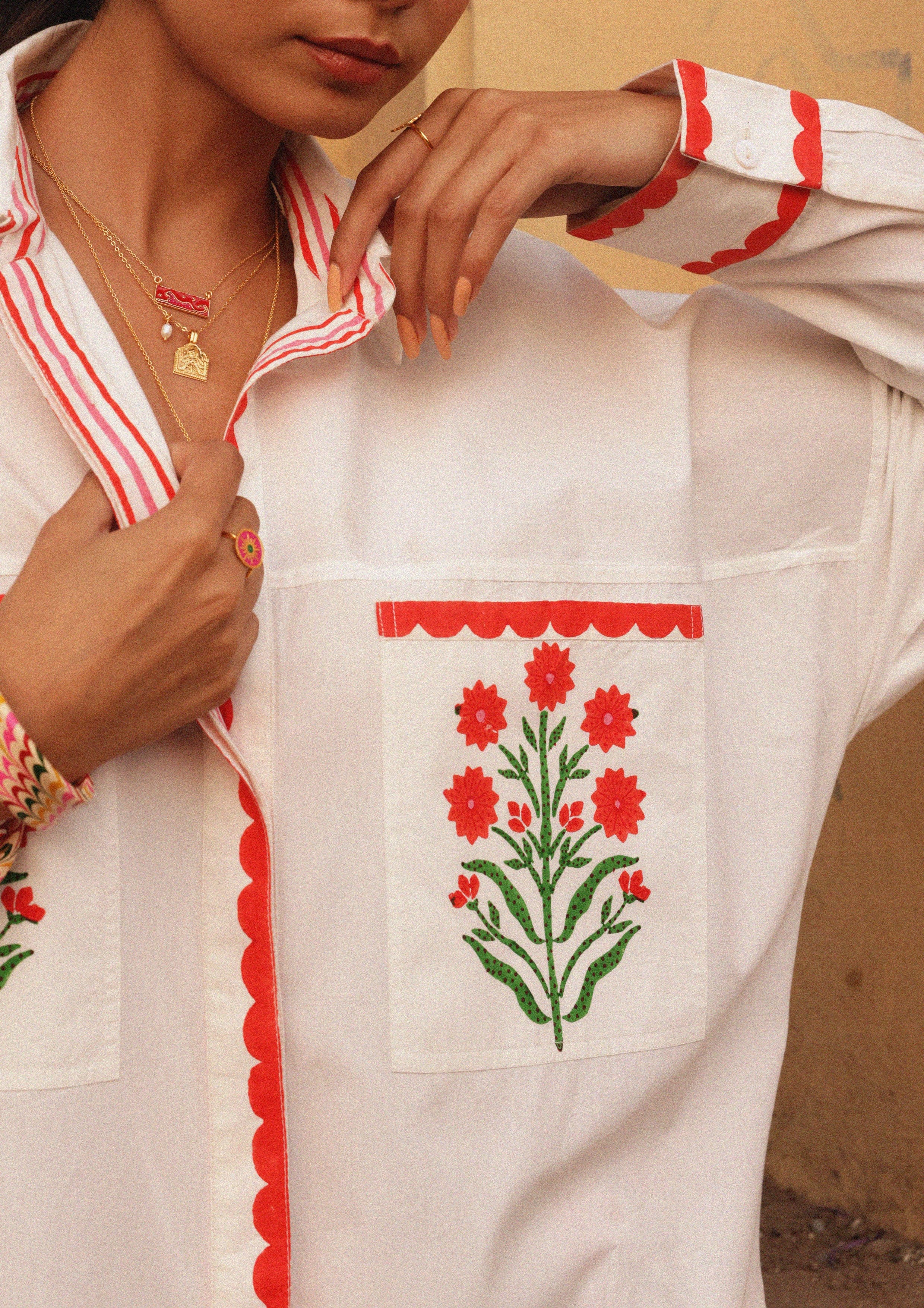 The Raw India Jaigarh shirt featuring blossom buta pattern in vibrant colors, displayed on a hanger against a neutral background.