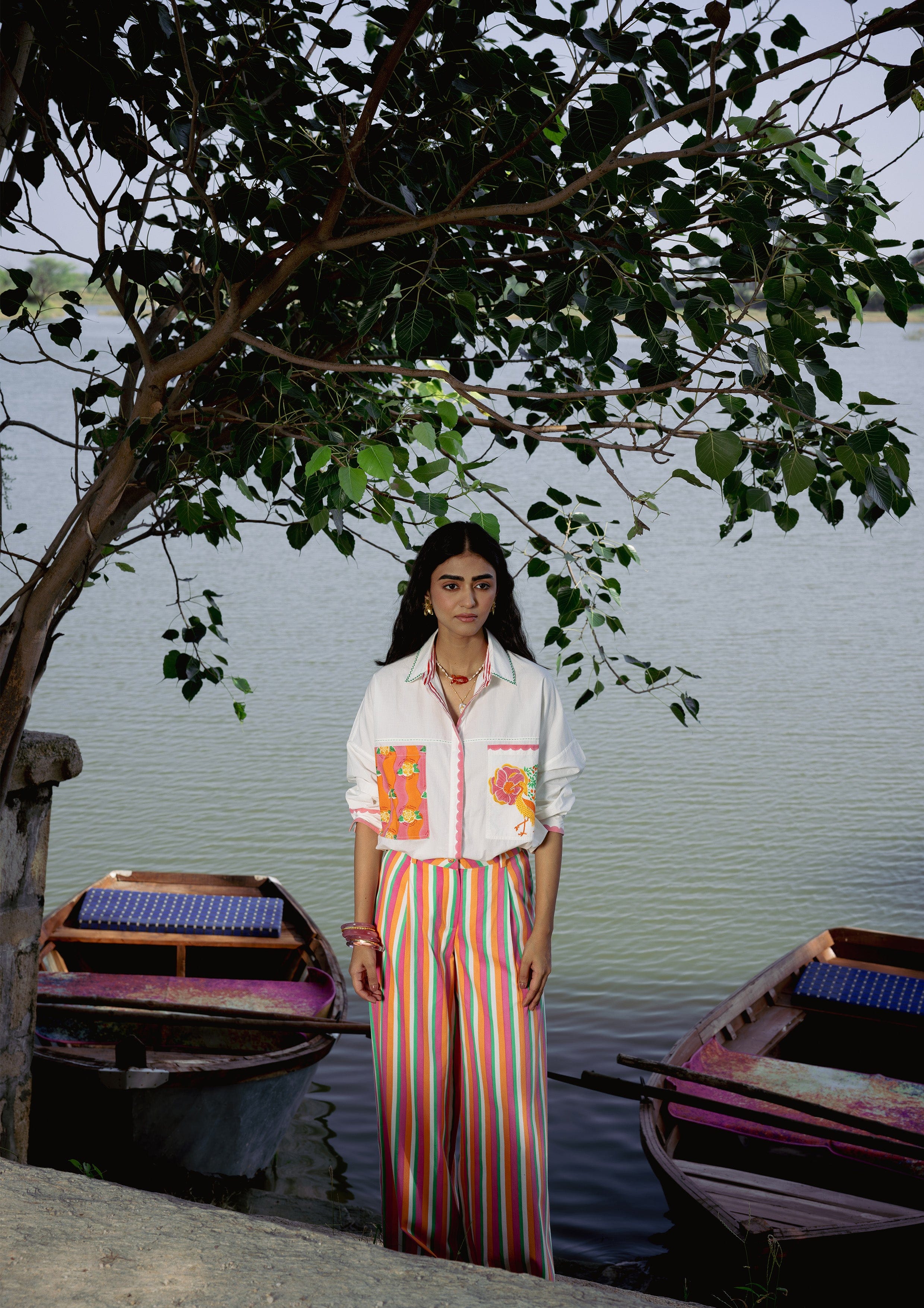 The Raw India Jaigarh Shirt River Crane, a stylish top featuring a river crane print, displayed on a hanger.