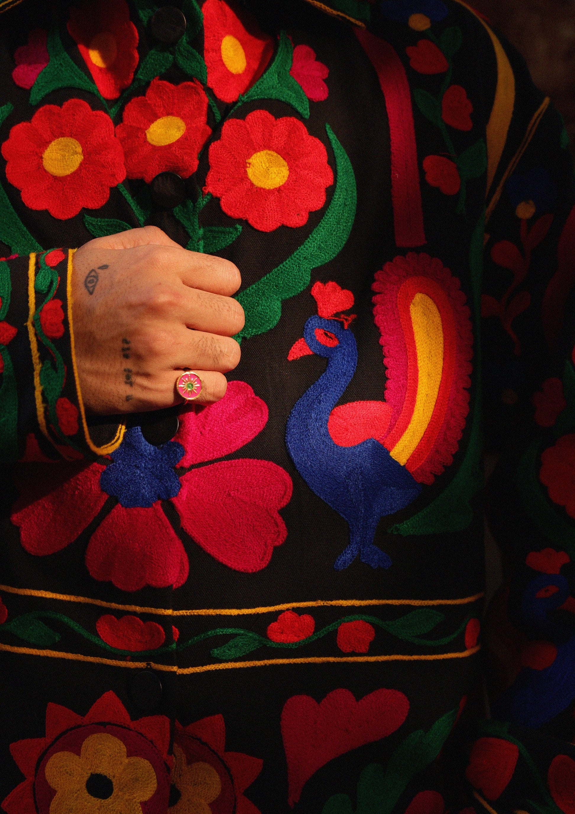 Jaipur jacket by The Raw India featuring intricate peacock embroidery on traditional jacket fabric.