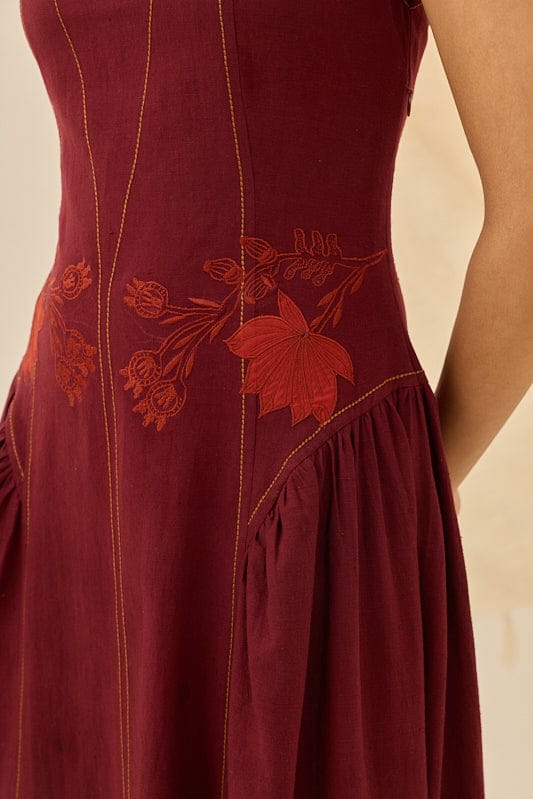 JODI Kuhu handloom dress with intricate patterns, featuring a flowing silhouette and vibrant colors, displayed on a hanger.