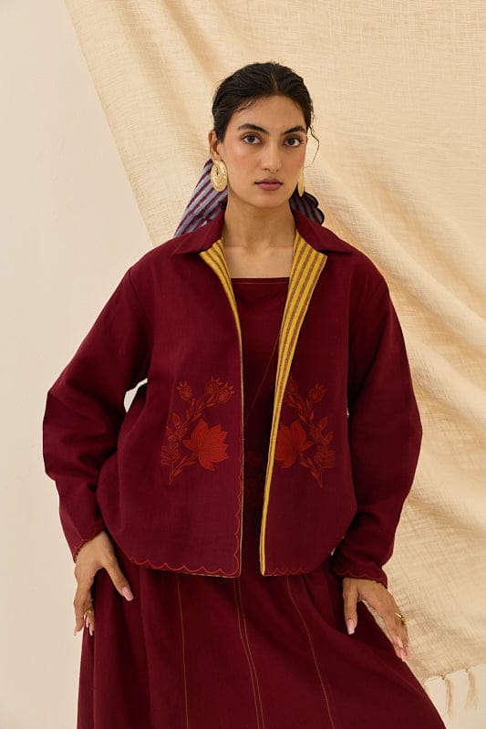 Reversible Kuhu handloom jacket by JODI featuring intricate woven fabric and stylish design, displayed on a hanger.