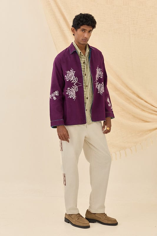 Reversible Morni handloom jacket by JODI, featuring traditional woven patterns and vibrant colors, displayed on a hanger.