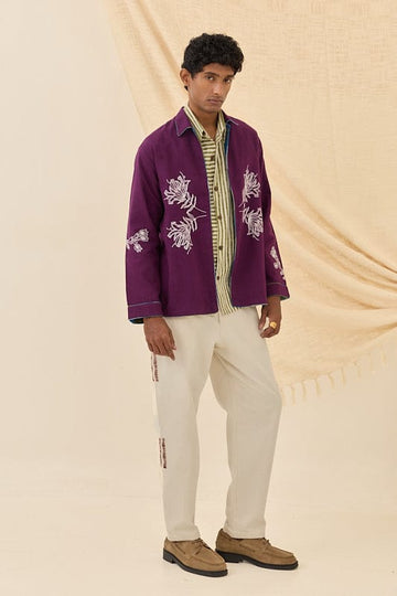 Reversible Morni handloom jacket by JODI, featuring traditional woven patterns and vibrant colors, displayed on a hanger.
