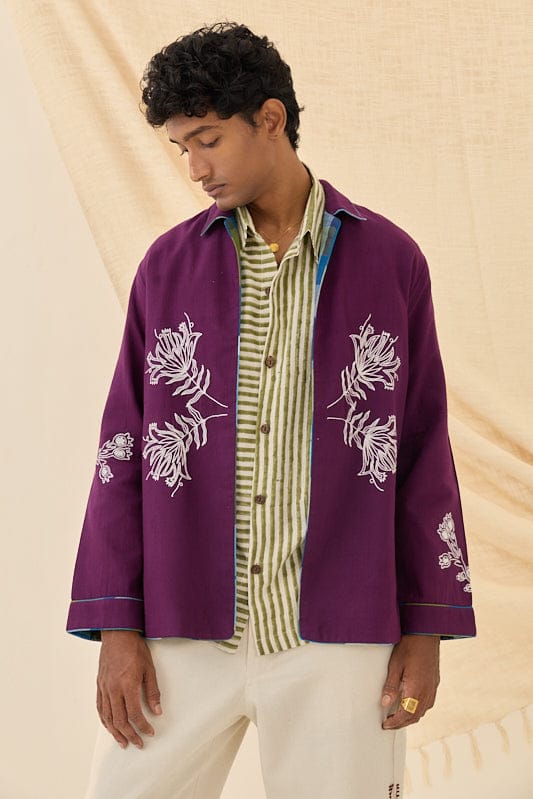 Reversible Morni handloom jacket by JODI, featuring traditional woven patterns and vibrant colors, displayed on a hanger.