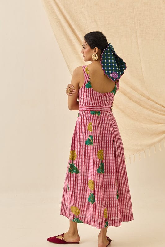 JODI Lali dress displayed on a hanger with a soft, flowy fabric and intricate detailing in a vibrant color.