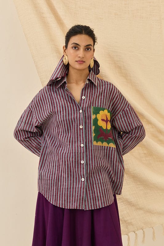 JODI Koyal shirt in vibrant fabric, featuring a stylish collar and button-down front, displayed on a hanger.