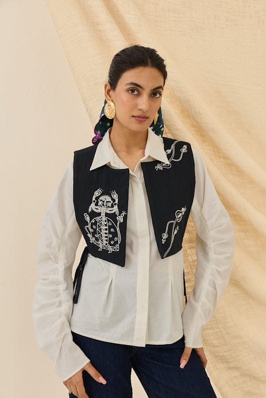 JODI Jugnu handloom bib waistcoat with traditional woven design, displayed on a hanger showing intricate fabric details.