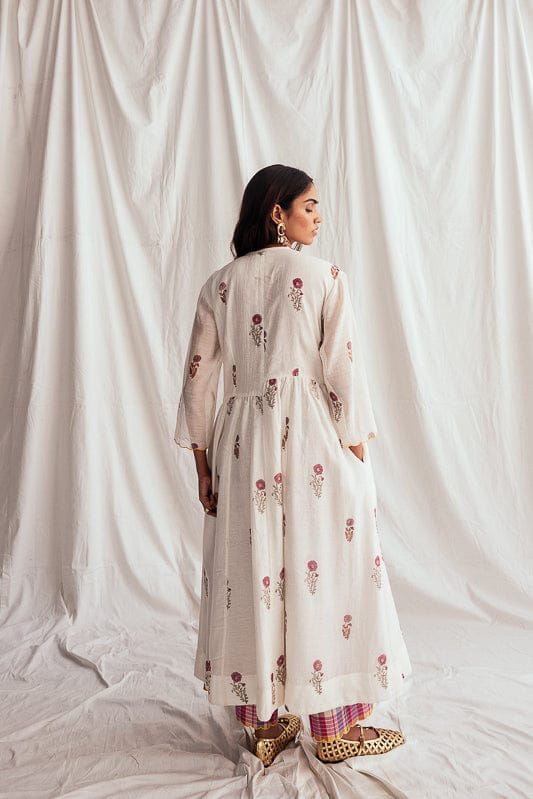 JODI Kulfi day dress featuring intricate embroidery and a flowing silhouette, displayed on a hanger with detailed fabric close-up.