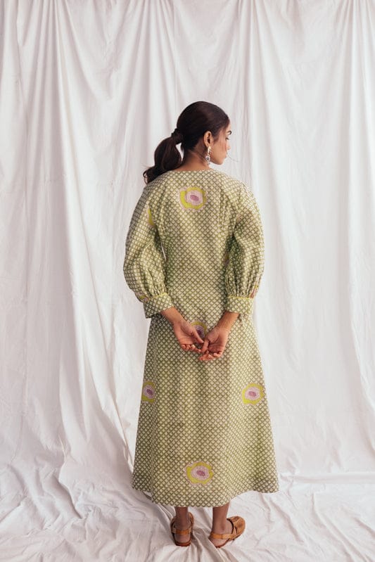 JODI Panna dress in a flowing, elegant design with soft fabric, showcased on a model in a lookbook setting.