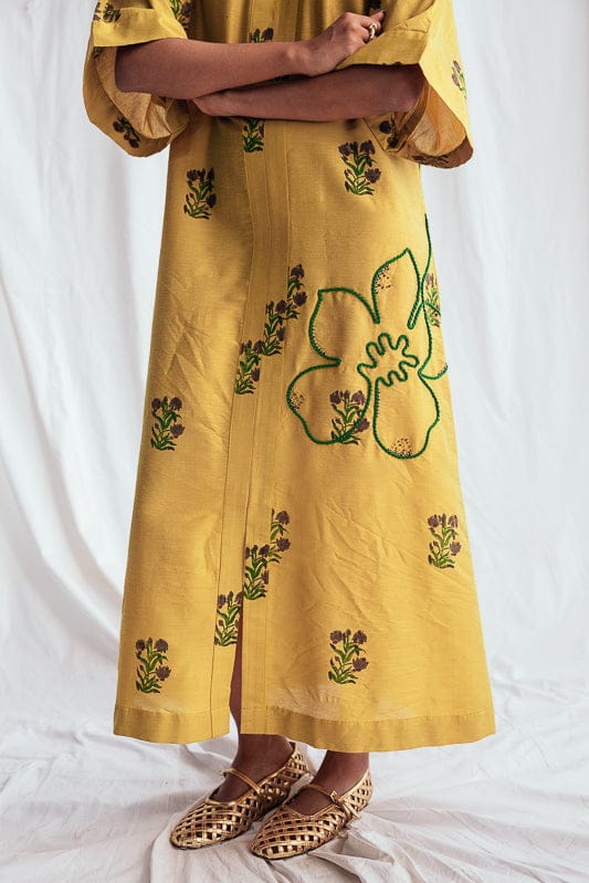 Nimbu silk day dress by JODI, featuring a flowing silhouette with intricate patterns and vibrant colors.