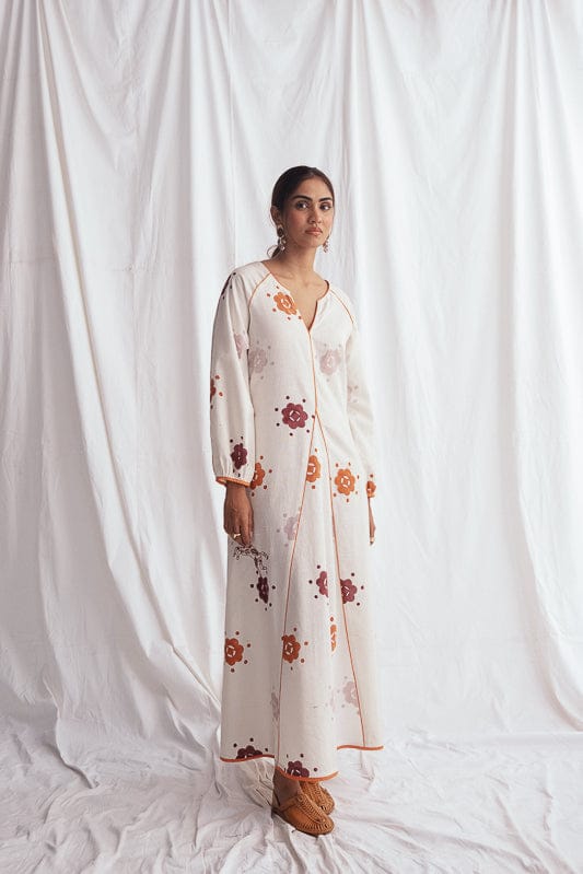 JODI Thandai peasant dress in vibrant, flowy fabric with traditional patterns, styled with boho accessories and natural surroundings.
