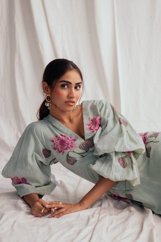 JODI Gulkand dress displayed on a model, featuring floral patterns and flowing fabric in a stylish, elegant design.