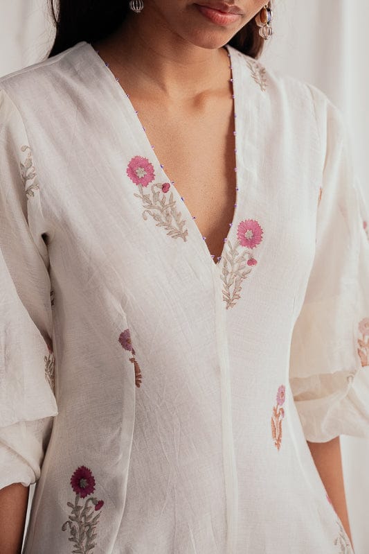 JODI Kulfi dress featuring vibrant floral print and flowing fabric, styled with a relaxed fit and elegant design.