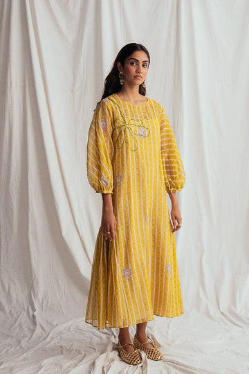 JODI Dhoop peasant dress with flowy fabric, intricate embroidery, and relaxed fit, featuring vibrant colors and bohemian style.