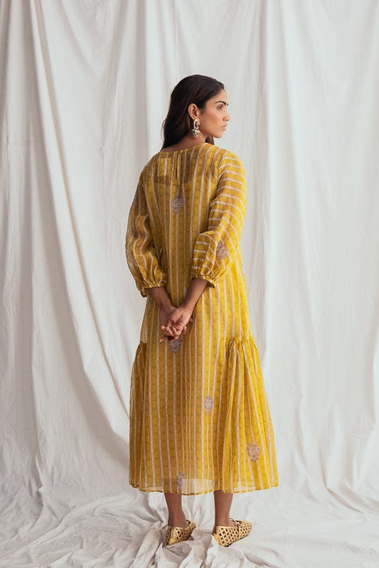 JODI Dhoop peasant dress with flowing fabric and bohemian style, shown on a model in a fashion lookbook image.