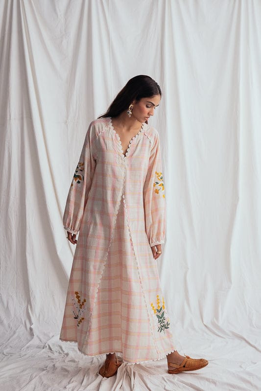 JODI Chataai peasant dress with flowing fabric and embroidered details, displayed on a hanger against a neutral background.