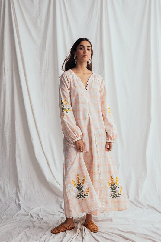JODI Chataai peasant dress showing flowy fabric, bohemian style, and relaxed fit with floral patterns and earthy tones.