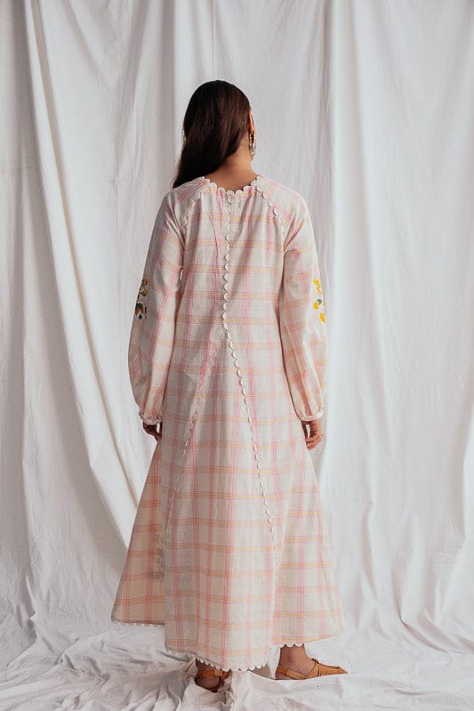 JODI Chataai peasant dress in soft fabric with embroidery, featuring a relaxed fit and bohemian style, modeled on a hanger.