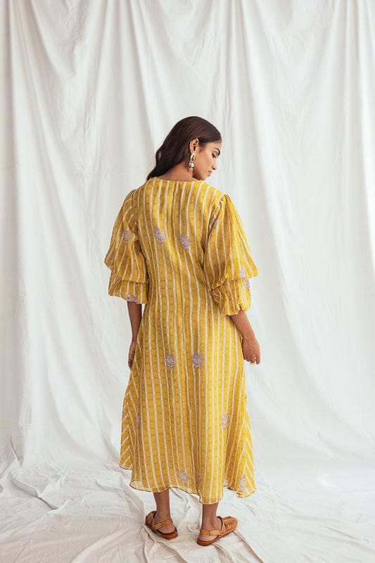 JODI Dhoop dress displayed on a model, showcasing a flowy, stylish dress with intricate details and vibrant colors.
