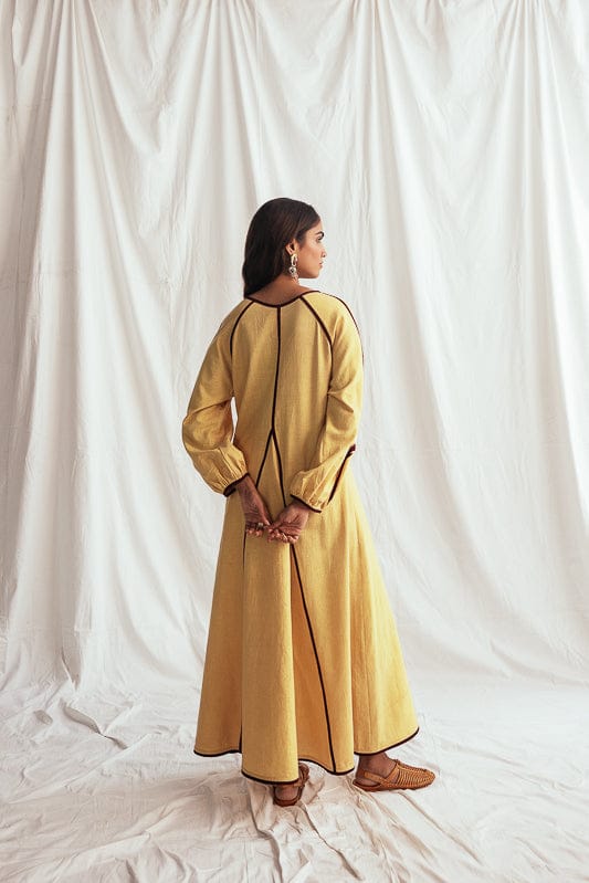 JODI Aamras handloom peasant dress featuring traditional patterns and comfortable fabric, worn by a model in a casual outdoor setting.