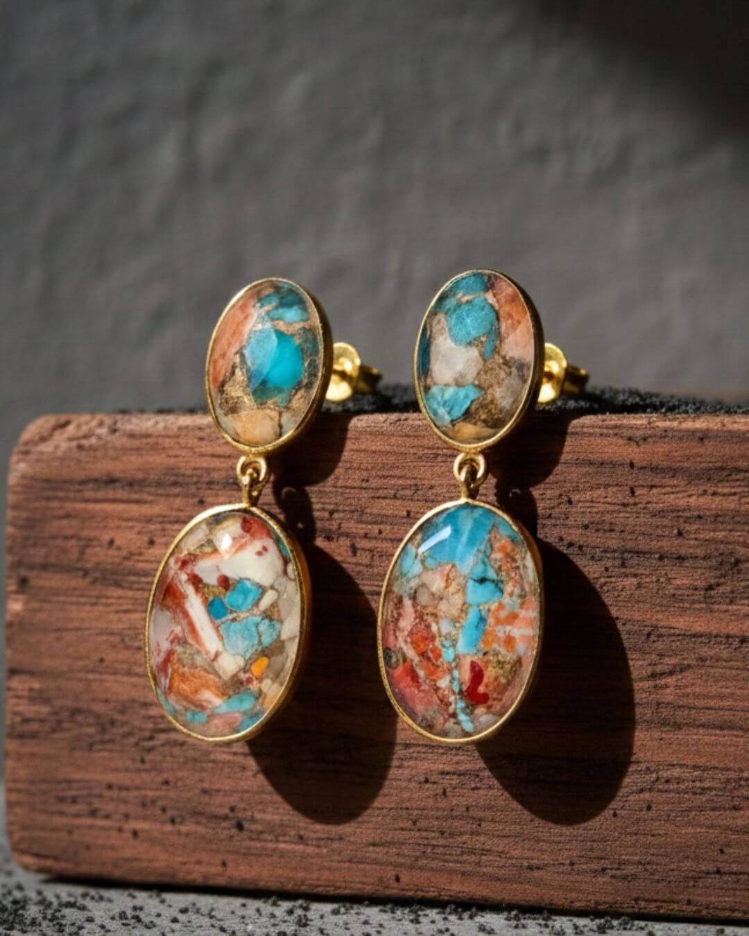 Bombaybirds Kandie earrings featuring gold-tone hoops with intricate design and dangling charms.