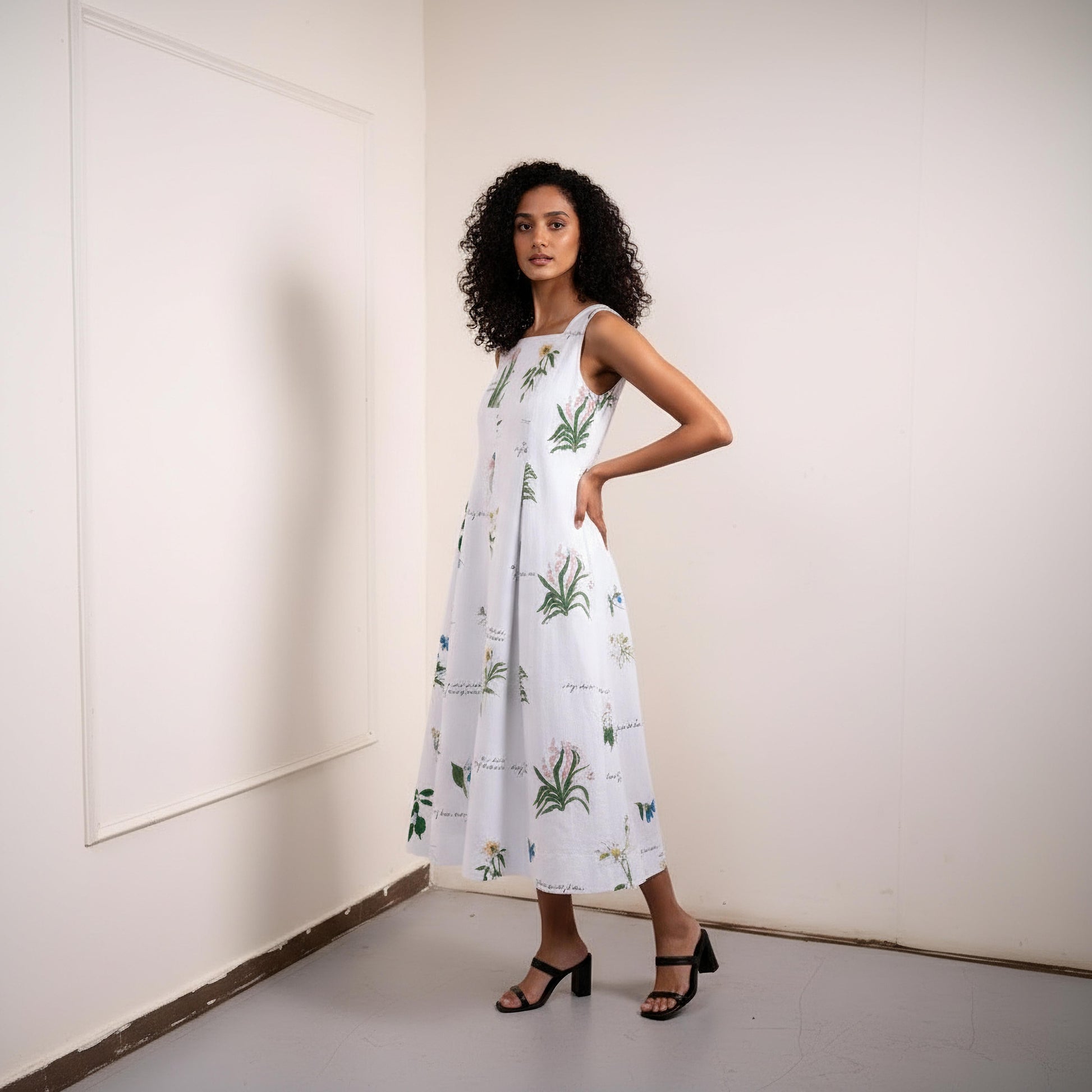 Doodlage Malaya printed dress with vibrant floral pattern, lightweight fabric, and feminine silhouette displayed on a hanger.